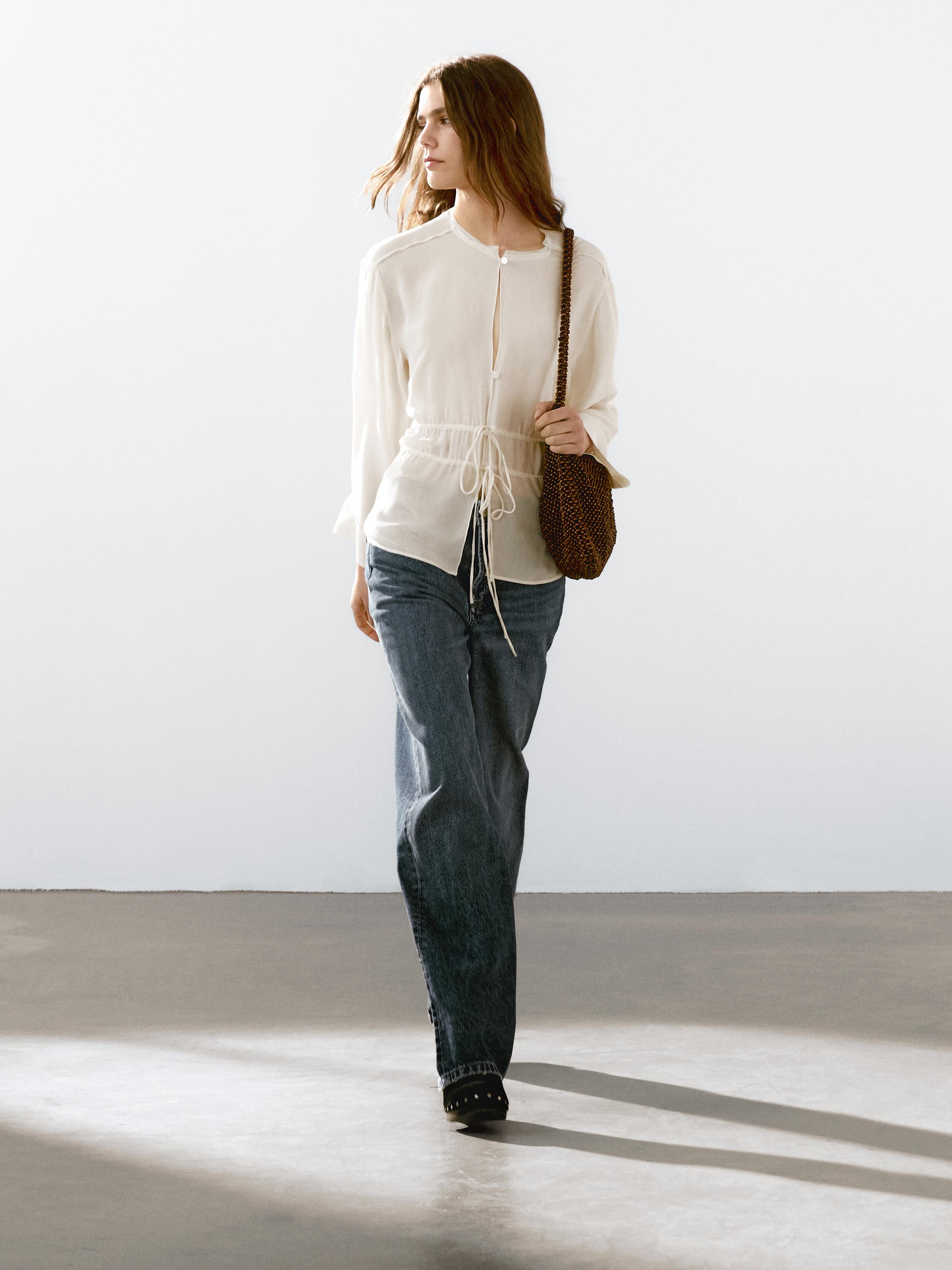 Flowing blouse in semi-sheer fabric. Crew neck. Long sleeves. Frayed finish. Drawstring fastening... | Massimo Dutti US