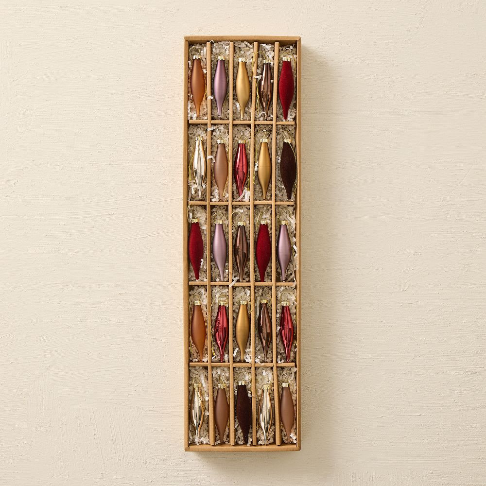 A long box of slim pointed glass ornaments in red, gold and mauve