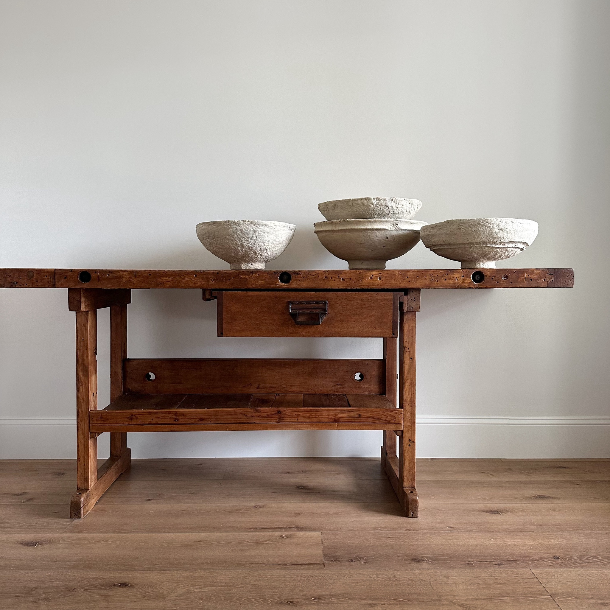 This vintage workbench is a timeless, versatile piece that can serve as a console, entry table, and more. Its rich, neutral wood tone showcases years of patina, and it features original iron hardware. The lower shelf and spacious drawer add functionality and storage. A showstopper that will elevate your space with charm and character.

#LTKHome