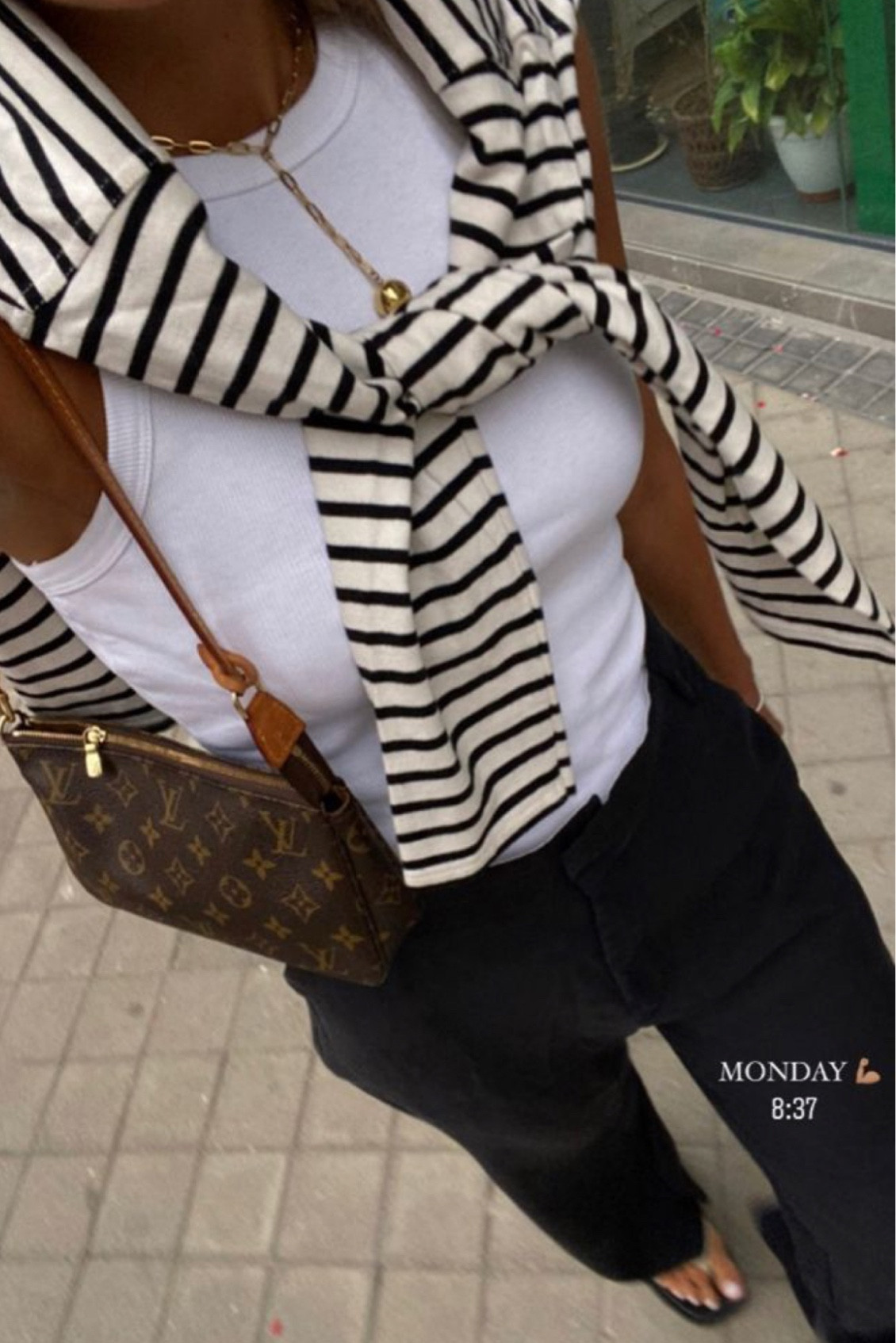 Black and white outfit. Sweater outfit. Summer outfits. Work outfit. Outfit for work. Travel outfit. Europe outfit. Pants outfit. Black and white striped sweater with a white halter tank and black pants with black flip flops and Louis Vuitton purse.

#LTKeurope #LTKstyletip #LTKtravel