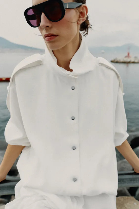 Jacket with a high collar and long sleeves with shoulder tabs. Featuring front welt pockets, elas... | Zara UK