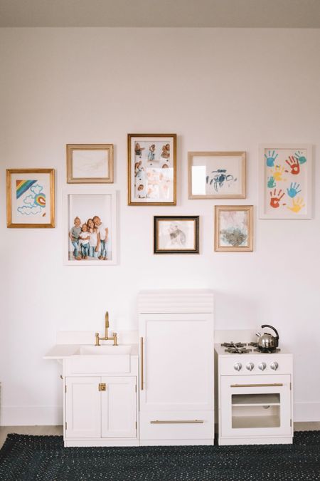 Gallery wall and kids play kitchen - Our new playroom & homeschool room with toy storage, a reading corner, kids desks, a gallery wall and the cutest home decor for a kids room!

#LTKHome #LTKFamily #LTKKids