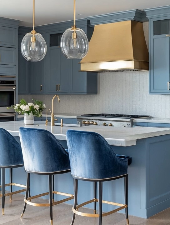 California coastal meets modern glamour.

This rustic navy kitchen brings together that effortless ocean-inspired calm with warm gold accents for a refined finish. The deep navy island and cabinetry create richness and depth, while the brushed gold faucet, hardware, and hood add that subtle luxury glow.

The key detail?
Navy velvet counter stools with gold frames. They instantly elevate the space and turn a simple kitchen island into a designer focal point.

To recreate this look:
• Navy or muted blue cabinetry (matte or satin finish)
• Gold accents — faucet, hardware, lighting, or hood
• Velvet or upholstered navy counter stools
• Soft white countertops to keep it fresh and balanced

It’s coastal, but not cliché.
It’s glamorous, but still relaxed.

Perfect for anyone who loves that “hot climate meets ocean breeze” aesthetic with a polished, intentional finish. 

 #LTKHome