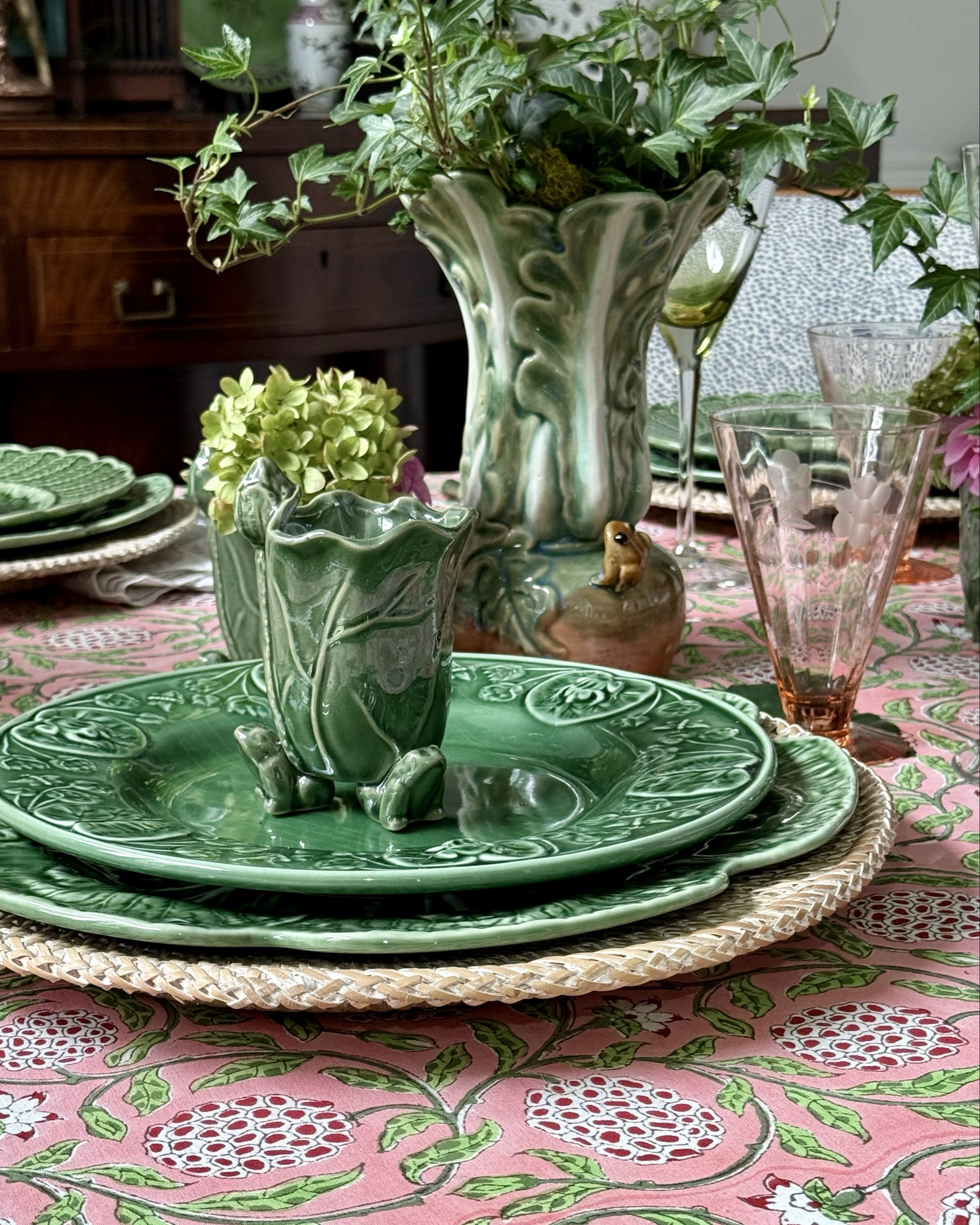Whimsical Table setting, Lily pads and frogs,pinks and greens on beautiful hand blocked tablecloth.Depression pink glassware ,the perfect color

#LTKSeasonal #LTKHome