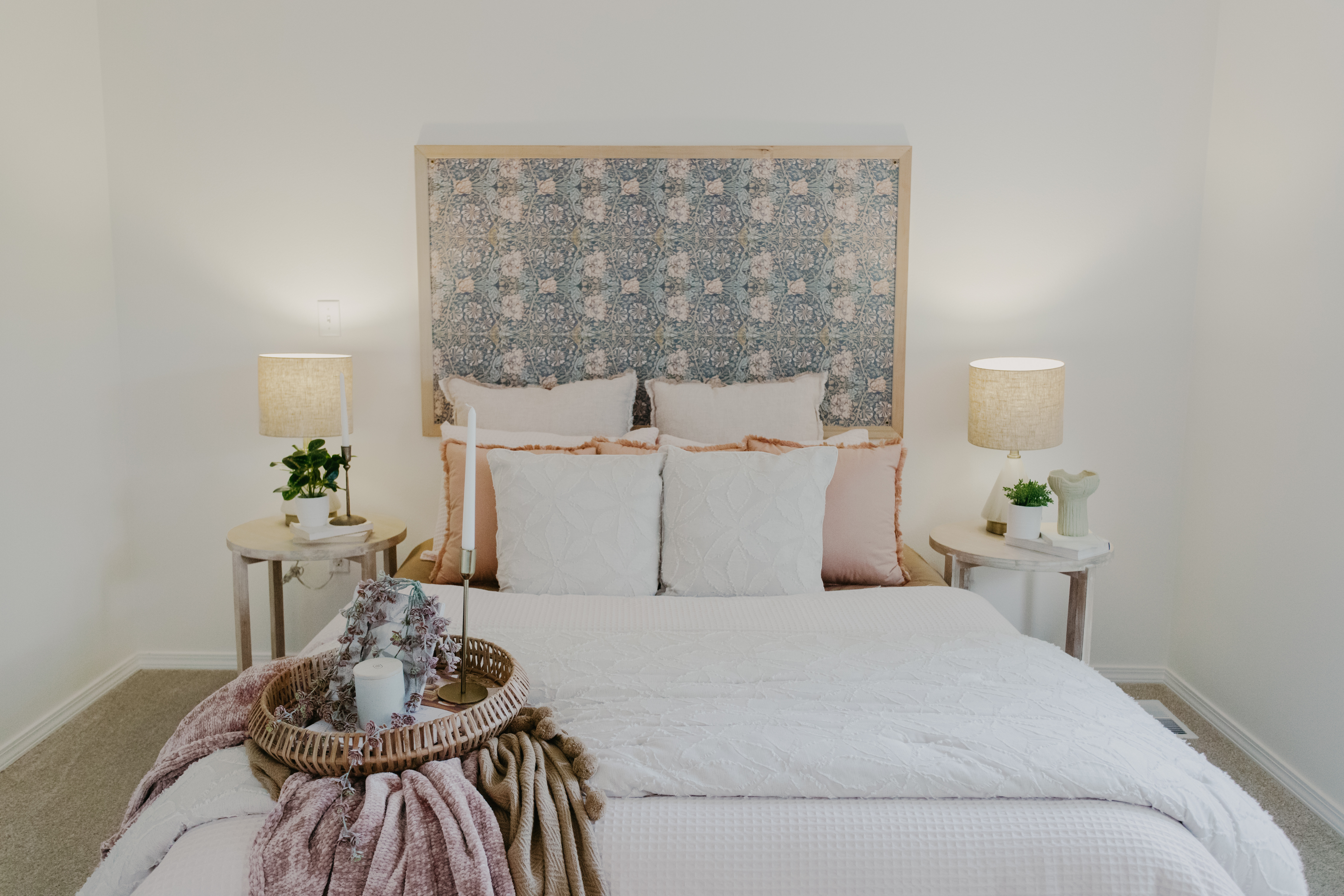 This cozy bedroom styled with soft neutrals and warm lighting creates a calming, inviting space. I love to layer pillows, use textured blankets, and simple greenery for a touch of charm and comfort.  The framed wallpaper behind the bed was a favorite project of mine! 

#LTKStyleTip #LTKHome