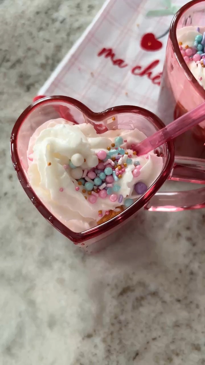 Have you tried this viral recipe yet?
Treat your little ones & yourselves this Valentine's Day to the best hot chocolate ever! 🫶🏻🤤
Here’s the recipe 🖤
Ingredients:
* One milk chocolate bar of your choice
* Swiss Miss hot cocoa powder(I used the one with marshmallows)
* 2 cups Heavy whipping cream
* Edible glitter
* Sprinkles
* FavoriteDay whip cream
* 1tsp vanilla extract 
Instructions:
1. Start by gently melting your chocolate bar (stirring frequently)
2. Add 2cups of heavy whipping cream 
3. Add Swiss Miss hot cocoa powder mix. Continuously stirring.
4. Add 1tbs vanilla extract 
5. Spray a little bit of your edible glitter
6. Continue stirring until the blend is smooth & the chocolate has melted completely
7. Pour into cups of your choice & put one ice cube in each cup (this step is optional)
8. Top it up with your favorite whip cream & sprinkles 
Enjoy!! 🫶🏻

#LTKWatchNow #LTKParties #LTKMostLoved