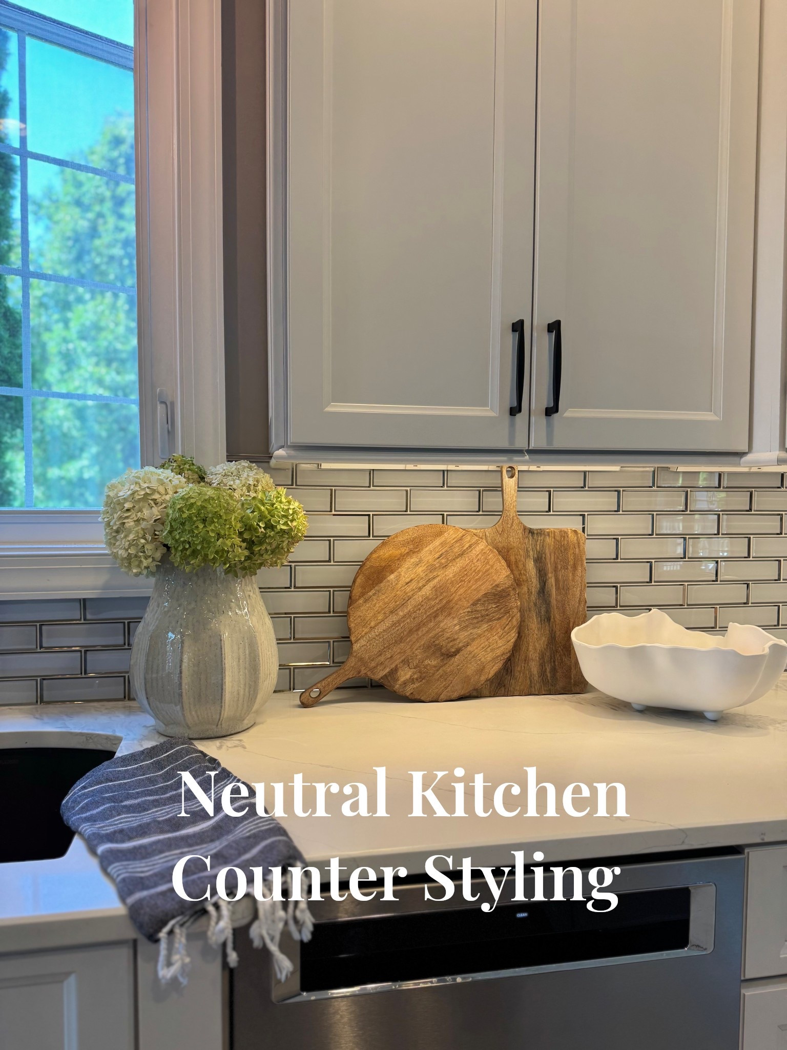 Neutral kitchen, warm and timeless inspiration. 
#kitchencounterdecor #neutralhome #kitchenstyling #timelesshome #transitionalmodern #scallopedbowl #cuttingboards #fruitbowl #everydaycozy #subwaytile #hydrangeadecor 

#LTKStyleTip #LTKSeasonal #LTKHome