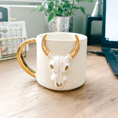 My new favorite hand crafted coffee mug. So beautifully made and one of a kind. Would make the perfect gift 🤍 #coffeemug #skull #pottery #ceramicmug #coffee #morning #homedecor #gold 

#LTKGiftGuide #LTKhome #LTKFestival