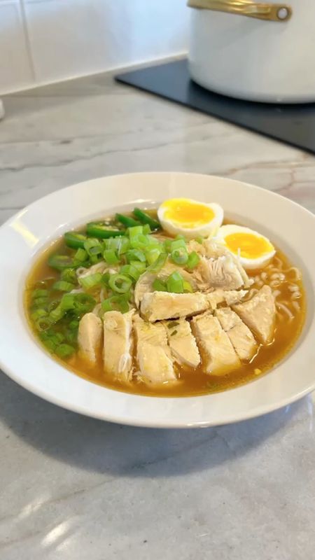 Chicken Ramen
Y'all were excited for this one...and let me say this was decent for the ease of it. I hope you give it a try! 

Comment LINK for Dutch oven and cookware. 

Recipe serves 4-6. 

1.5 lbs Chicken breast (I used tenderloins)
2T butter
4tsp sesame oil
4tsp ginger, minced
1.5tsp garlic, minced
6T low sodium soy sauce
4T mirim (or sub for 4T rice vinegar and 2tsp sugar)
64 oz chicken bone broth
2tsp salt
6 large eggs
4 packs chicken ramen (only using 1 packet seasoning)
1 cup sliced scallions
2 jalapeños sliced (optional)

Preheat oven to 375°F.
Heat oven safe pan (I.e. Dutch oven) over medium and add butter and chicken, season top of chicken with 1 packet seasoning from ramen. Cook chicken tenderloins about 3-5 minutes on either side and transfer to oven to roast for 15 min. 

Meanwhile boil about 8 cups water. Add eggs for 8 min and transfer to an ice bath, reserving water. 

When chicken is done, remove from Dutch oven and reserve the drippings. Start your broth combining sesame oil, ginger and garlic, and heat for 1 minute. Add mirim, soy sauce and salt, and heat for 2-3 minutes. Add broth and cover, bringing to a boil. 

Add ramen (no seasoning) to your reserved water cook about 5-8 minutes or until noodles are tender. 

Slice chicken and peel/slice eggs. 

Assemble ramen, chicken, broth, eggs, scallions and jalapeños (if desired). Enjoy!!!

#recipe #ramen #homecooking #momskitchen #momscooking #thaicuisine #kitchengadgets #kitchensupplies #kitchenwares #weddingregistry #registry #easyrecipes #soups #thirtyminutemeals #dinnerideas #dfwmoms #dfwblogger #dfwinfluencer #dfwcreator #viralrecipes #discoveryunder5k

#LTKGiftGuide #LTKSeasonal #LTKhome