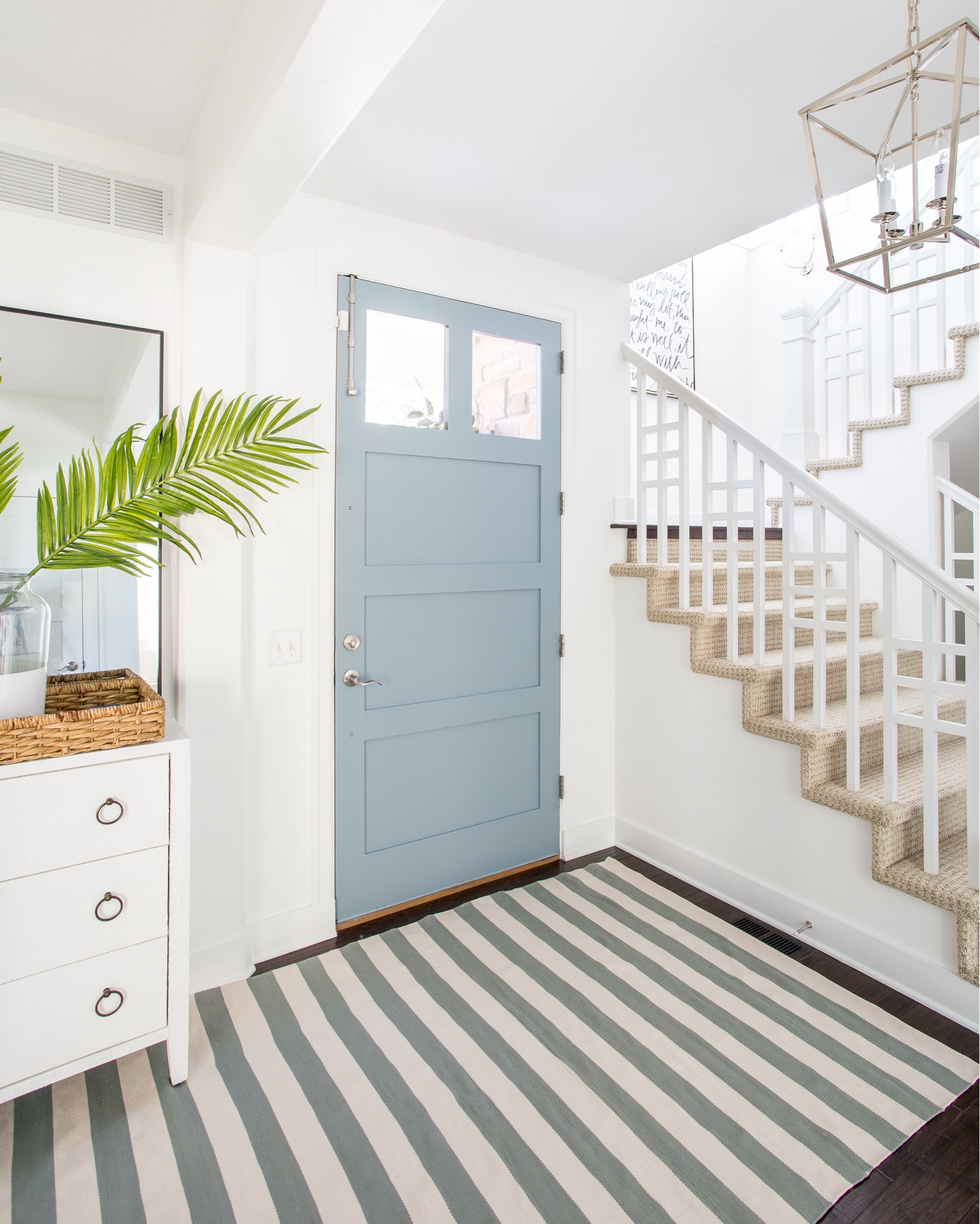 *Most of these items are currently on sale* Our Omaha entryway decorated for summer with a white glossy raffia cabinet, blue and cream striped rug, lantern pendant light, “It Is Well” canvas art, tall thin black framed mirror, faux palm leaves and a paint dipped vase.

#ltkhome #ltkseasonal #ltkstyletip #ltkfindsunder50 #ltkunder100  coastal decorating, foyer ideas, blue and white

#LTKSaleAlert #LTKHome #LTKSeasonal