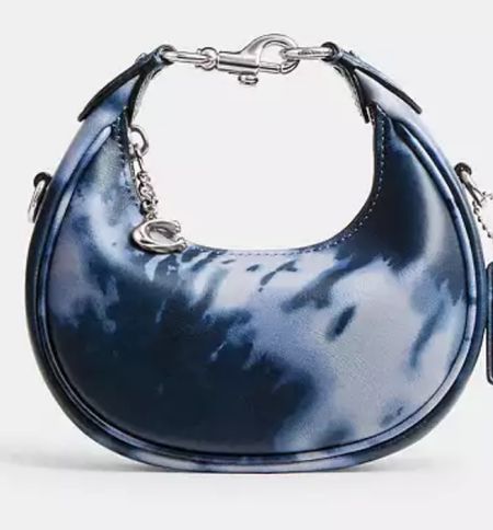 Coach Jonie Bag With Tie Dye Print

Ahead of the curve, our Jonie is a rounded style that’s part crescent silhouette, part hobo and all attitude. The compact style is crafted of smooth leather printed with our sophisticated spin on a classic tie-dye pattern and finished with a secure zip-top closure detailed with our C hardware. Carry by hand and wear as a wristlet with the interlocking top handle for nights out or add the detachable leather crossbody strap for days on the go

#LTKGiftGuide #LTKItBag #LTKStyleTip