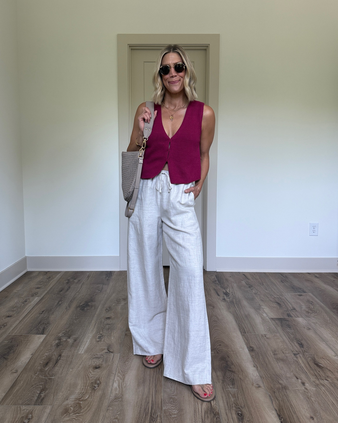 Wearing small linen pants, small sweater vest, sandals tts