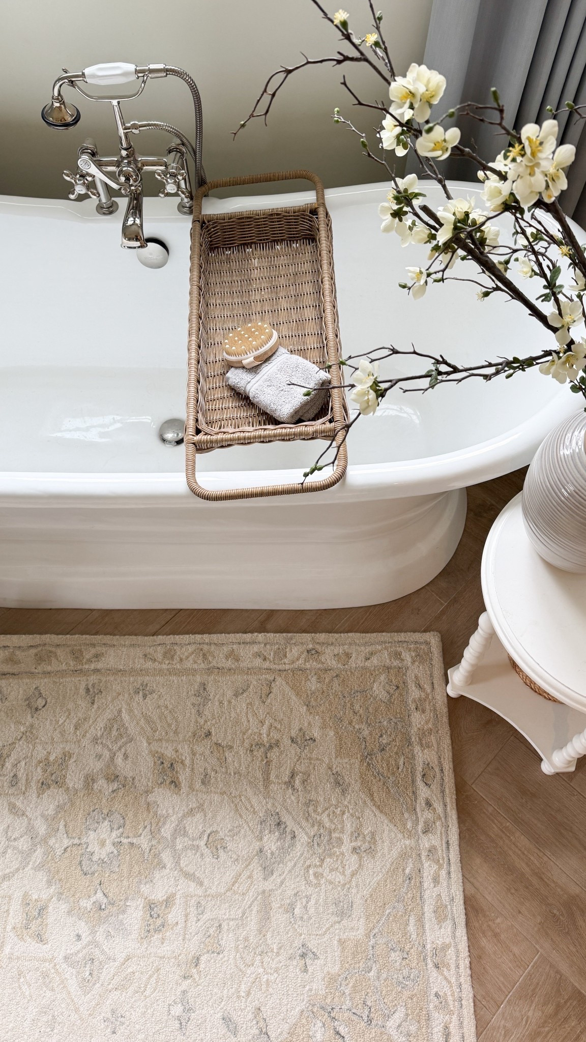 It’s amazing what a little warmth and texture can do. Adding a wool rug and rattan bath caddy brought so much warmth to our primary bathroom. The rug works with both warm and cool tones, so it’s very versatile. 

#LTKHome