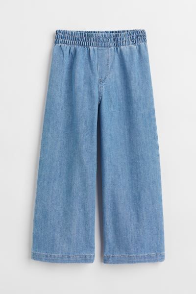 Conscious choice  Relaxed-fit jeans in denim. Covered elastic at waistband, mock fly, and wide le... | H&M (US + CA)