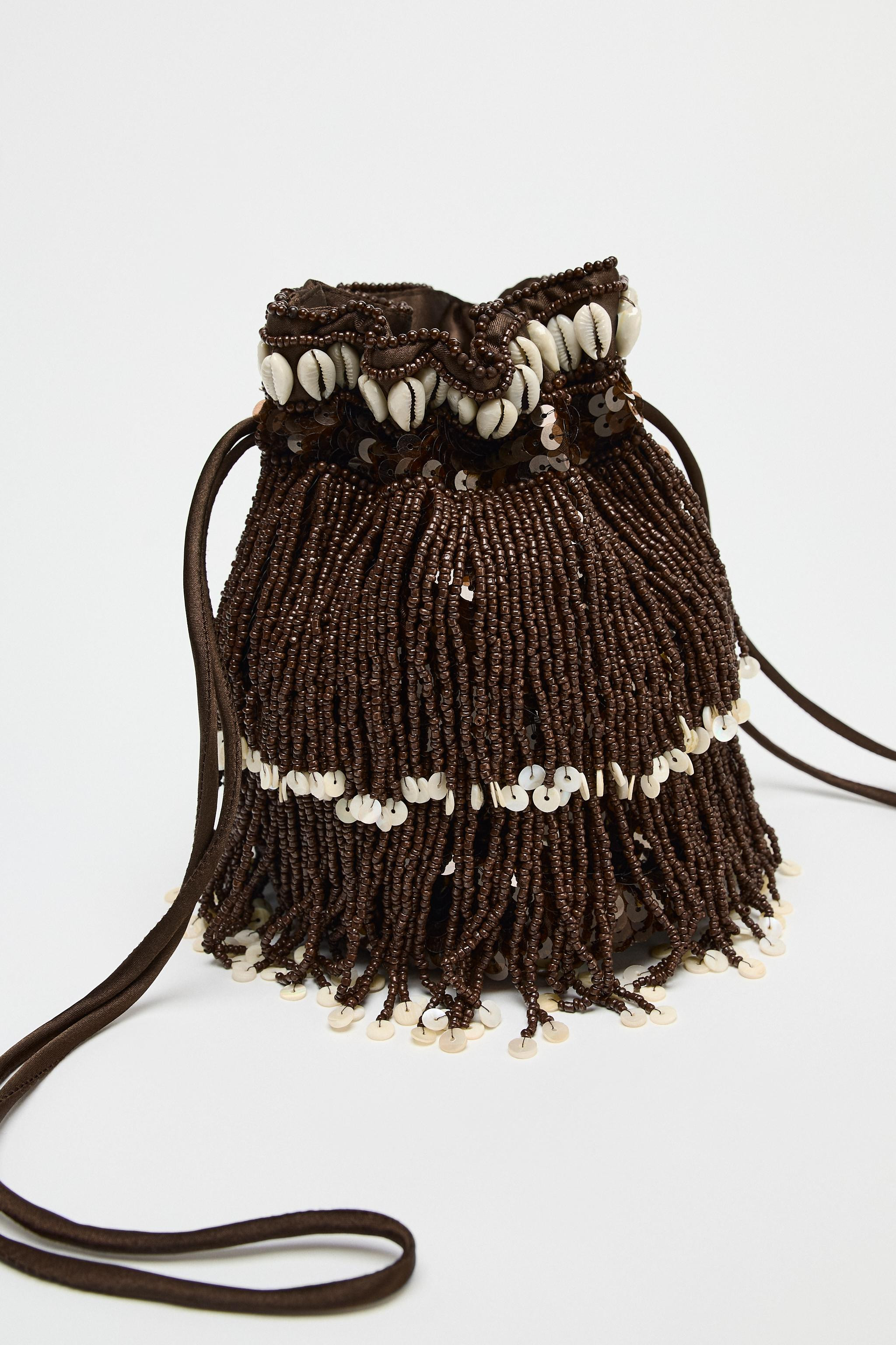 Mini bucket bag with glitter exterior, fringe, and shells. Lined interior. Double shoulder straps... | Zara US