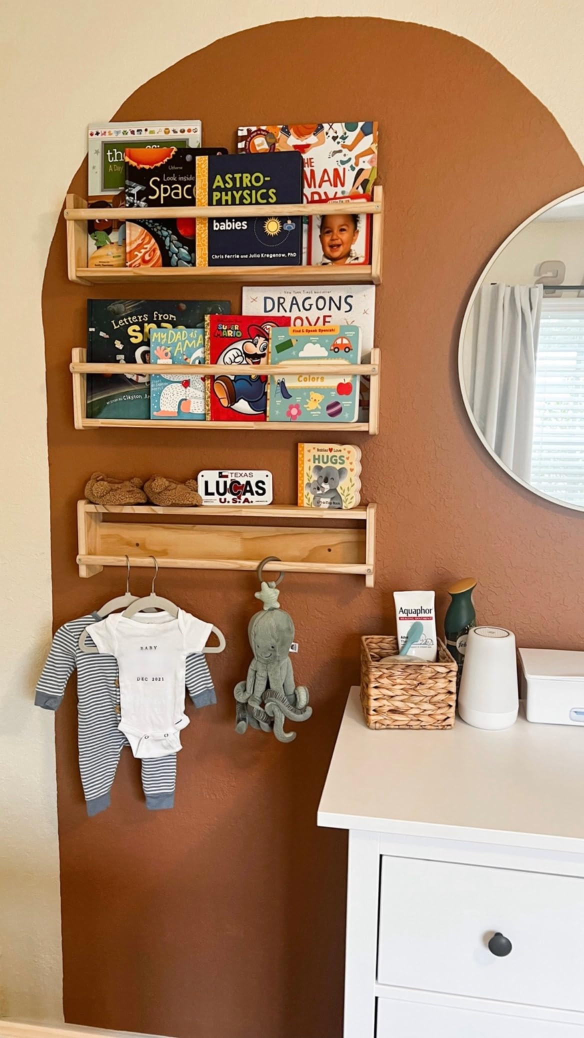 A nursery nook that’s as cute as it is practical! These wall-mounted wooden bookshelves are the perfect way to display your baby’s favorite books while keeping everything organized and within reach. The warm painted arch adds a cozy touch, and the lower rack doubles as a sweet spot for baby clothes, keepsakes, and soft toys. A thoughtful setup for small spaces that blends style and function!

nursery bookshelf ideas, baby book storage, nursery wall decor, baby room organization, wooden nursery shelves, cozy baby room, small nursery ideas, neutral nursery inspiration 

 #LTKBaby #LTKBump #LTKFamily