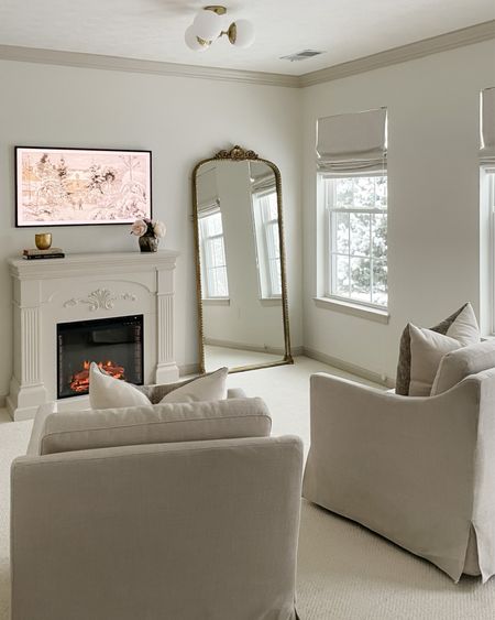 Cozy sitting area in our bedroom: Target swivel chairs, Samsung Frame TV, fireplace, Primrose mirror, faux peonies 

#LTKhome #LTKstyletip #LTKFind
