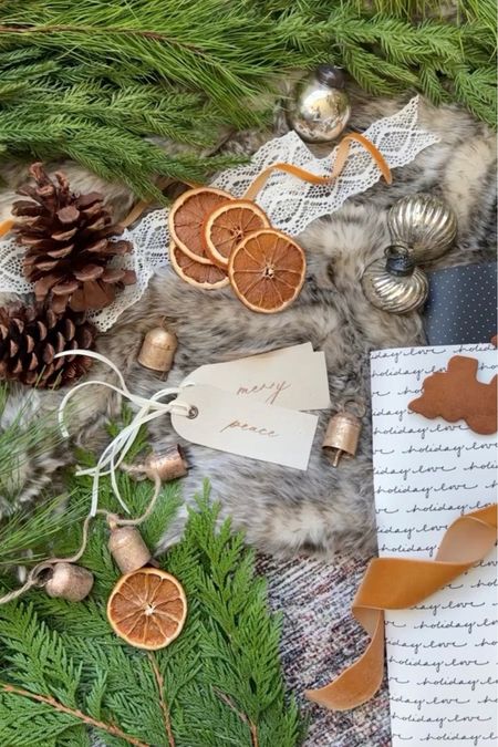 Holiday gift wrapping embellishments. I try and grab smaller ornaments, bells and pinecones before they sell out to add to the top of gifts!

Christmas gifts, gift wrapping, christmas ornaments, mercury glass ornaments, pinecones, gift tags, stocking tags, dried orange slices, vintage bell garland, vintage bells, faux fur blanket, holiday decor, christmas decor


#LTKHoliday #LTKhome #LTKSeasonal