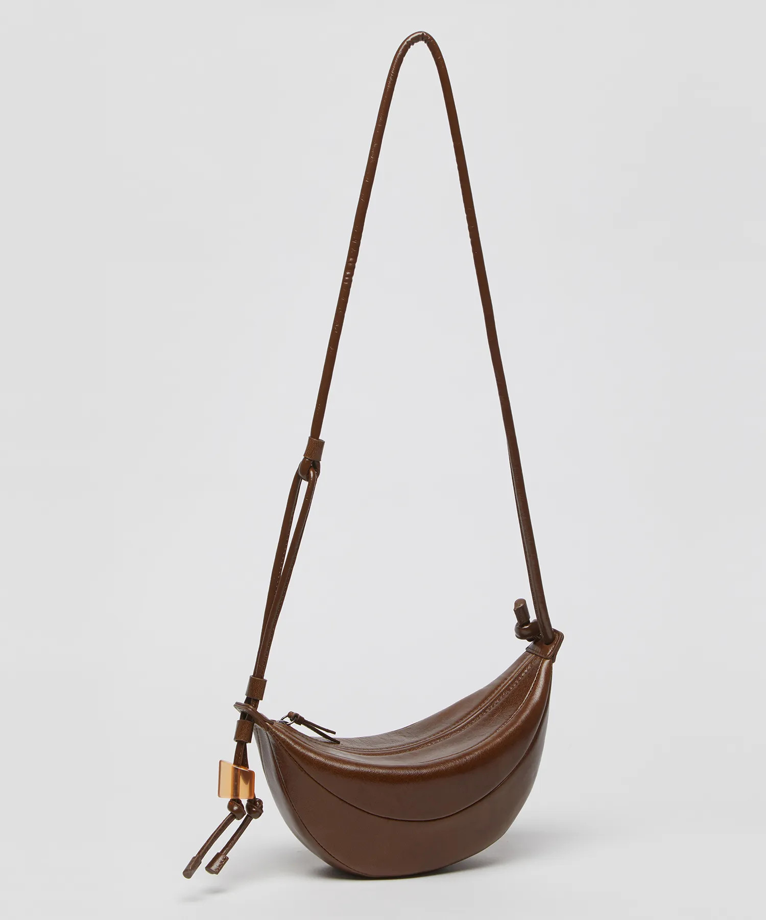 MUSINSA | Archivépke Small fling bag((Glossy crack camel)_OVBAX25201GCM | Musinsa Global