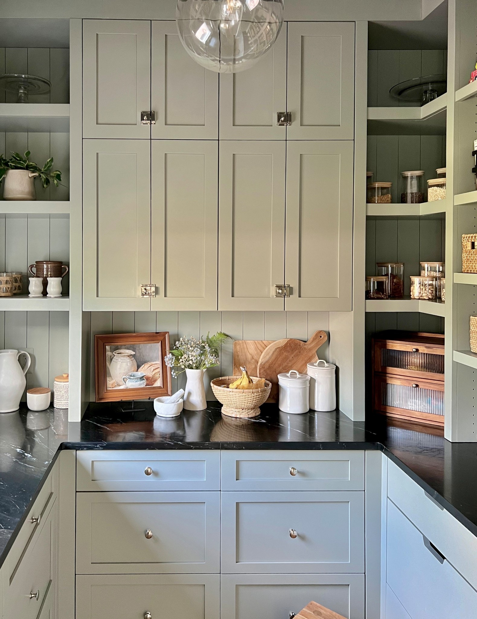 Moody kitchen pantry, open shelving, food storage organization using baskets, wire bins, drawer dividers, tiered shelving, reeded bread box. Cabinet Paint color is BM Oil Cloth

#LTKHome #LTKSeasonal #LTKStyleTip