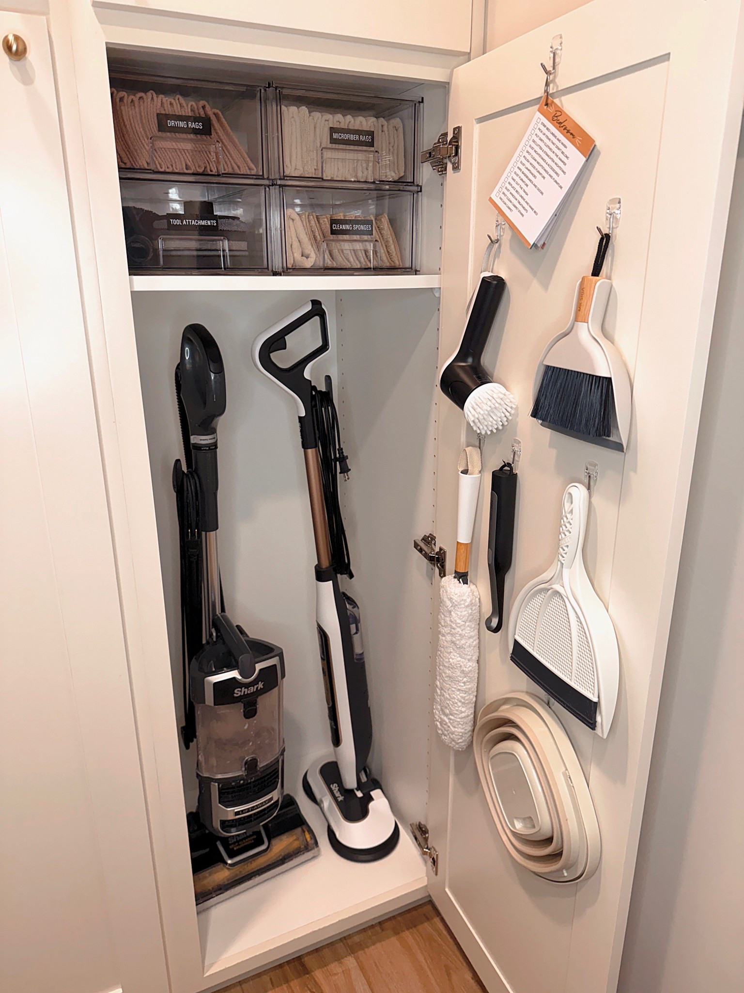 This vacuum cabinet keeps all floor-care tools in one organized, easy-access space. Storing the vacuum upright with dedicated hooks for attachments prevents clutter and protects the equipment. Door-mounted organizers hold cords and cleaning tools while labeled bins keep extra supplies neatly contained. A smart storage solution that makes daily cleanup faster and stress-free.

Highly searched words:
vacuum storage cabinet, vacuum closet organization, vacuum and mop storage, cleaning tool organizer, utility cabinet organization, upright vacuum storage, cleaning supply cabinet, small space storage solutions, home organization ideas

#LTKSeasonal #LTKHome #LTKmomlife