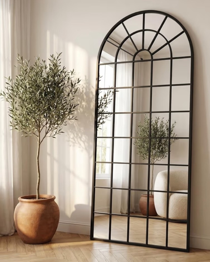 Large arched window pane mirror with that rustic farmhouse and modern feel that instantly makes a room look brighter and more elevated. 🌾 Perfect for an entryway, living room, bedroom, dining room, hallway, or fireplace wall when you want a statement piece that adds depth, light, and architectural character. The oversized black frame and arched window design give it that collected farmhouse look while still feeling clean and modern. 

Add this mirror if your space needs a dramatic focal point with warm modern farmhouse energy. 🍅🪿🤎

#LTKHome #LTKSeasonal #LTKOver40
