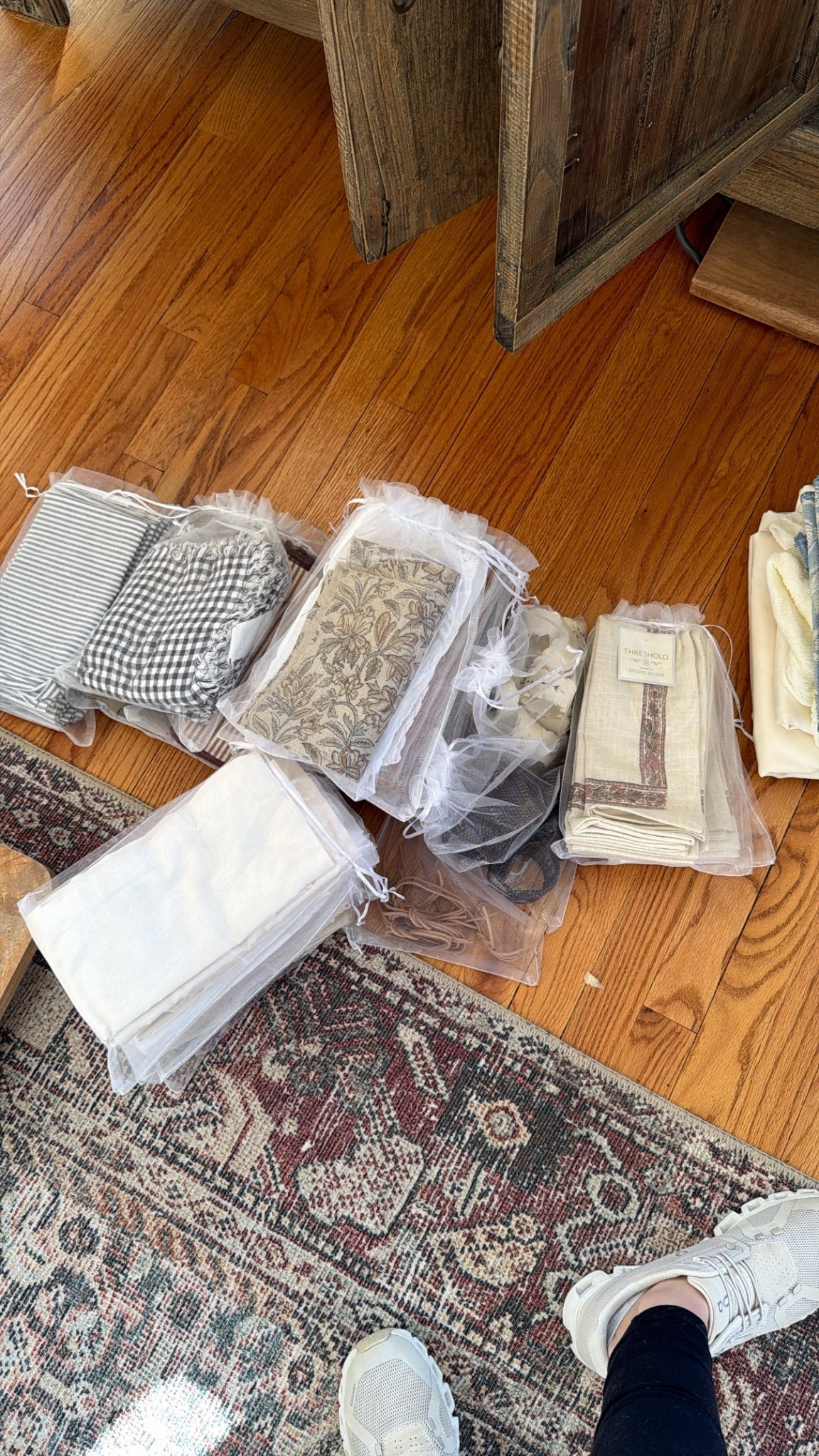 Organizing table linens! Using organza bags for napkin sets and napkin rings. Hanging with s hooks from tension rods! 

#LTKvlog #LTKdayinmylife #LTKHome