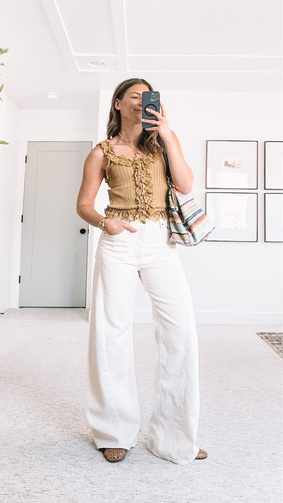 Easy everyday outfit for moms who want to feel put together without trying too hard. These white high waisted wide leg jeans are my forever formula, styled here with a chartreuse ruffle tank that feels elevated and never basic, plus a colorful textured bag to pull it all together. Perfect for school pickup, lunch with friends, or running errands and still feeling like yourself. Tap to shop the wide leg jeans, the ruffle tank, and the bag, everything is linked here for you.