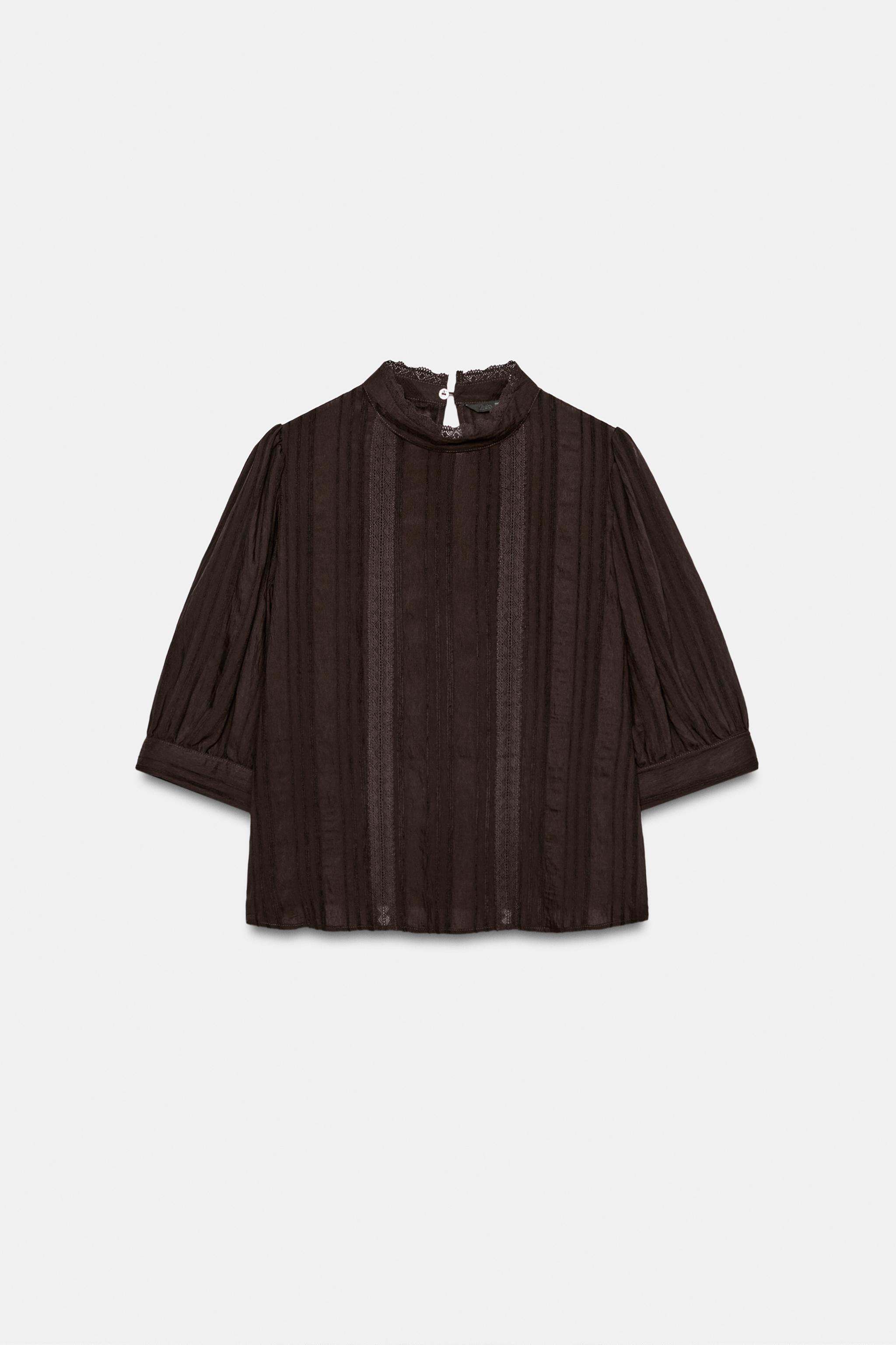 High-neck shirt featuring short puffed sleeves. Tonal lace trim details. Back opening with button... | Zara DE