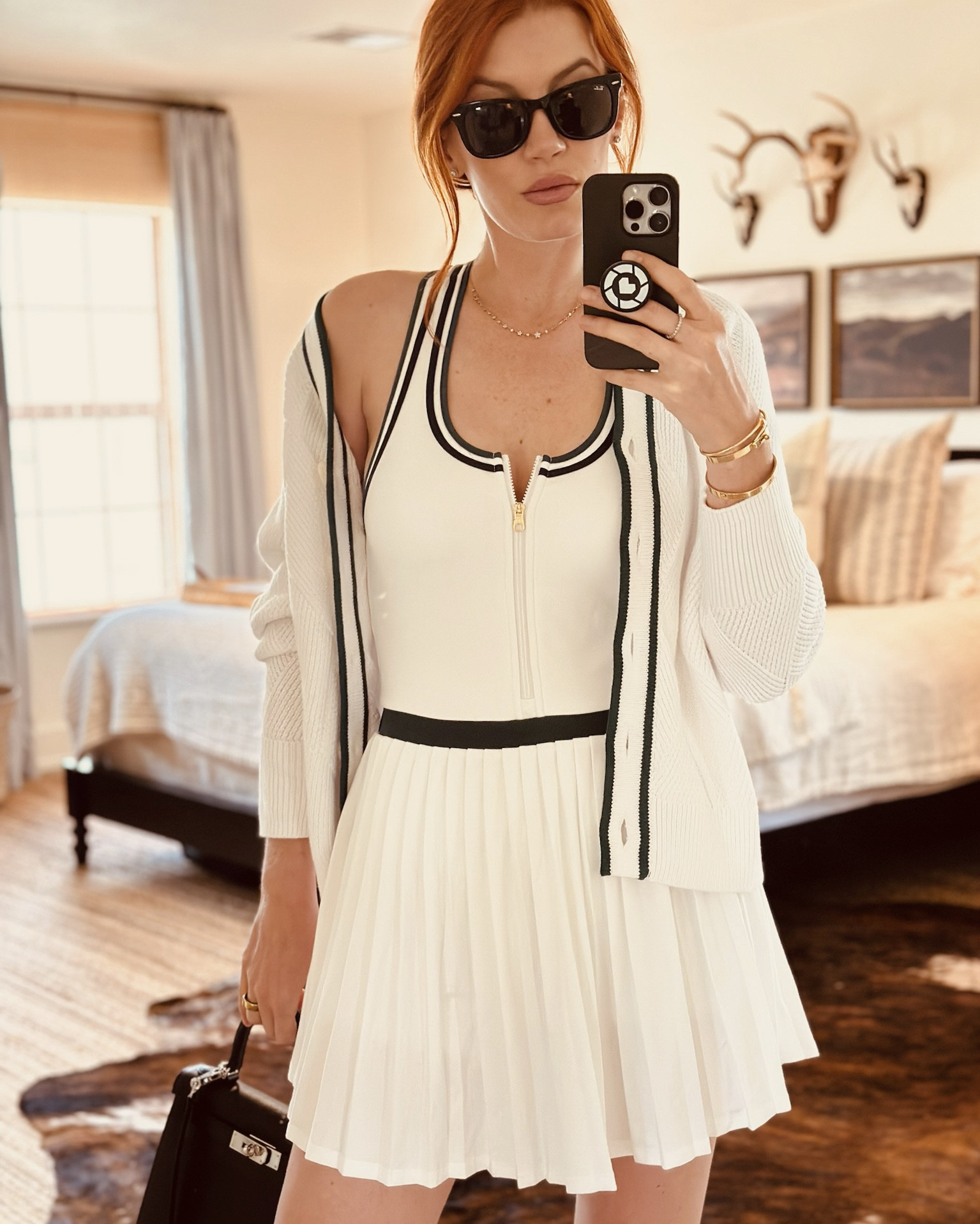 Showing you guys a close up of the details of my new Varley tennis set. The trim has navy and green retro stripes and it’s fully lined with removable pads so you don’t have to worry about a bra with the racer-back. I added the cardigan because it finishes the look off - it has a diamond knit pattern and matching green trim. It’s very old school tennis and I love how timeless and classic this set is.

#LTKU #LTKActive #LTKFitness