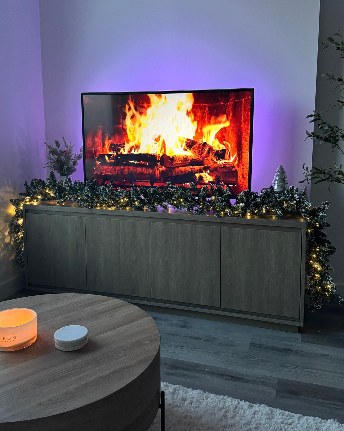 Tv stand holiday decor 🎄✨🎀 used this  garland with lights from Amazon to make this extra cozy vibe! Other decor is from home sense! LED lights on the back of the tv add to the coziness too!

#LTKcanada #LTKwinter