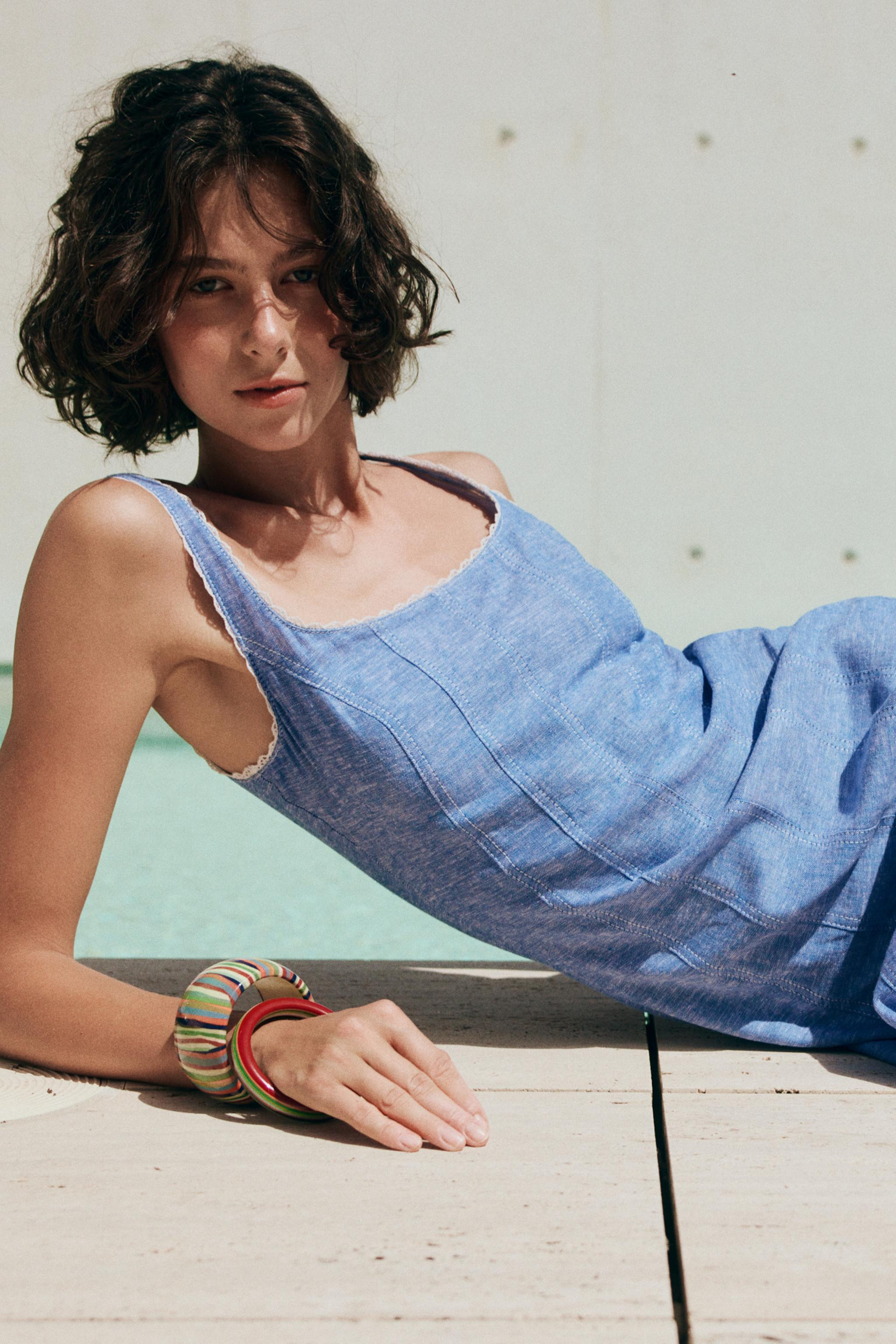 Dress made of linen. Round neckline and wide straps with lace trim. Side hidden in-seam zip closu... | Zara US