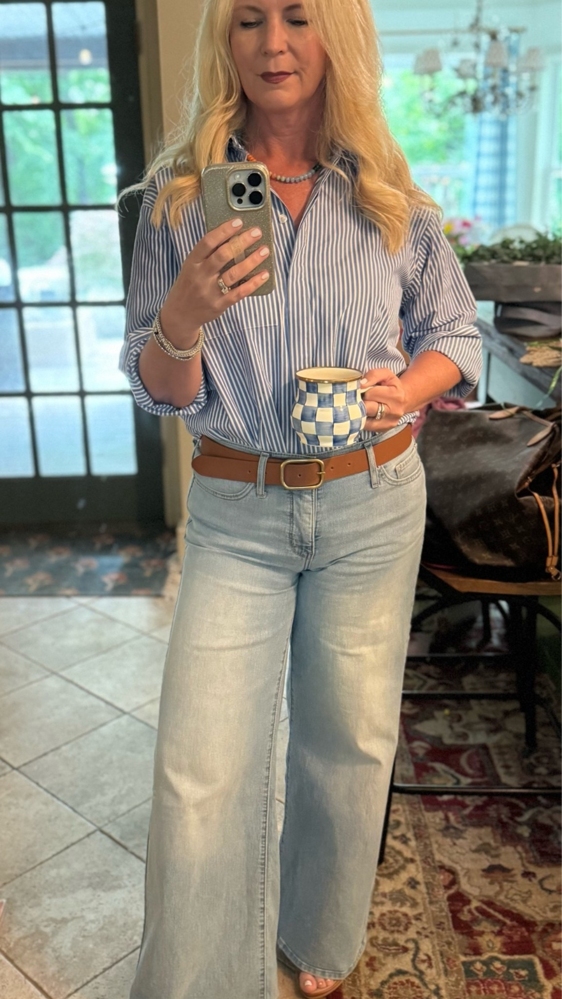 Classic and effortless outfit of the day. Stripe women’s button up shirt, wide leg denim jean, brown leather belt, brown sandals, beaded necklace, silver bracelets, sterling silver bracelet, enamel blue check mug.

#LTKootd #LTKOver40 #LTKSaleAlert