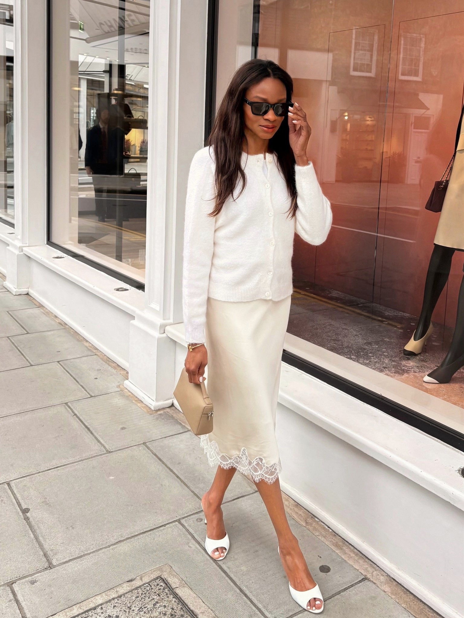 Lace-trimmed silk midi satin skirt and white Manolo Blahnik heels slippers
