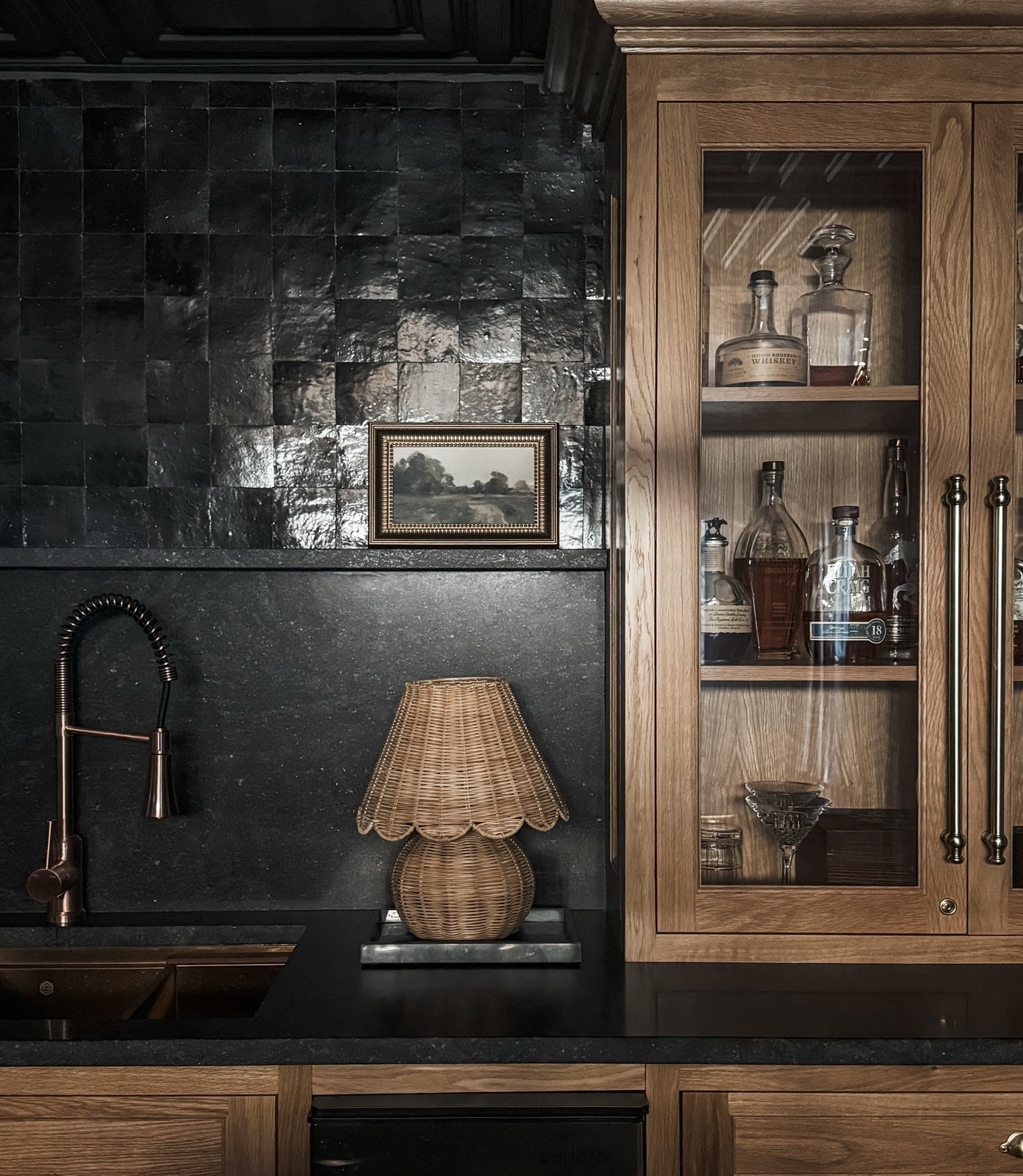 When form meets function 🍸 This bar moment features a woven rattan lamp for warm ambient lighting, a dramatic dark tile backsplash, rich wood cabinetry with glass doors, a bronze bar sink faucet, sleek stone countertops, and a compact beverage refrigerator—all working together to create a space that feels both elevated and inviting.

#designinspo #barareagoals #rattanlighting #moodyinteriors #eanesinteriors


#LTKHome #LTKOver40 #LTKvlog