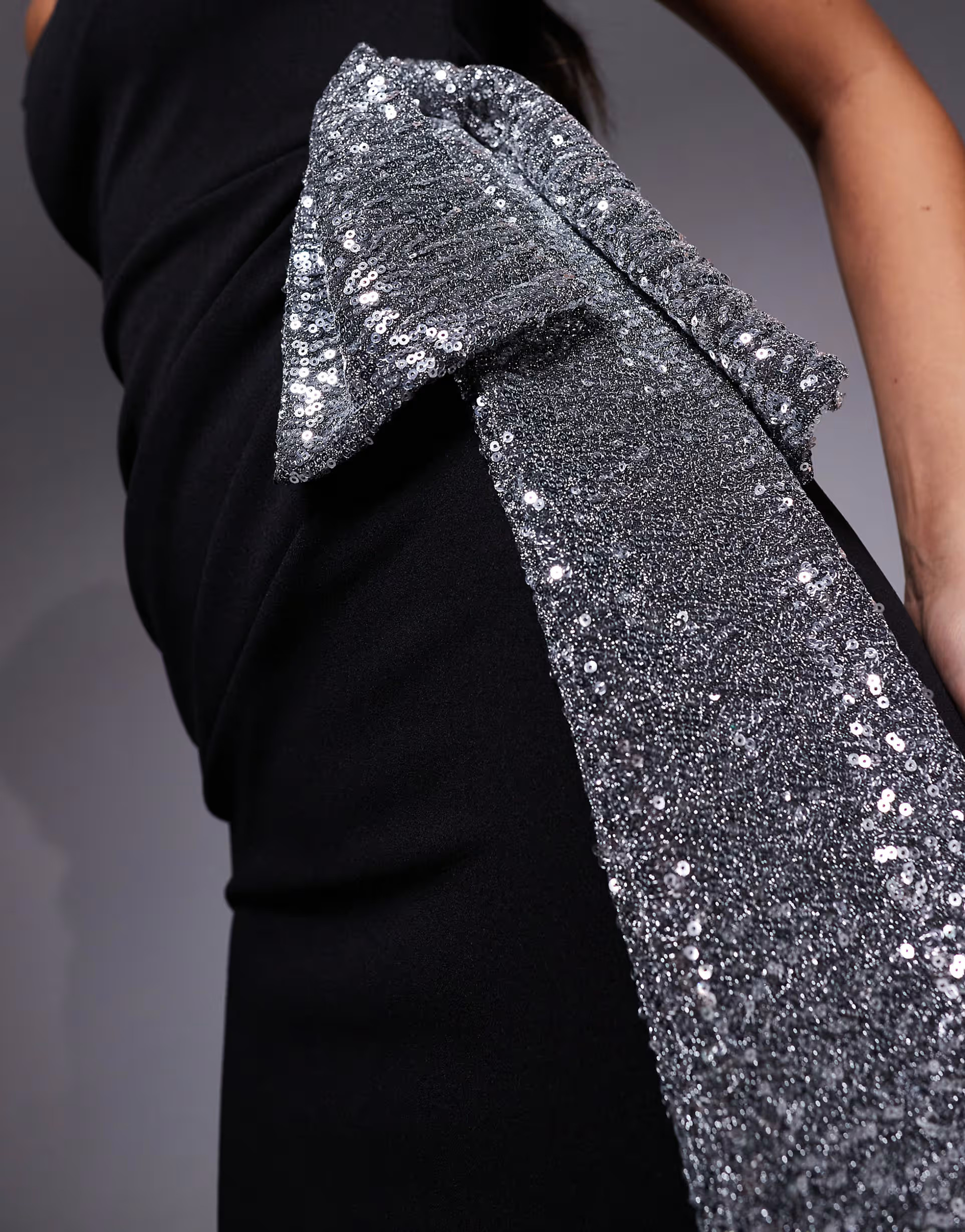 ASOS DESIGN crepe twist off shoulder mini dress with silver sequin bow detail in black | ASOS (Global)