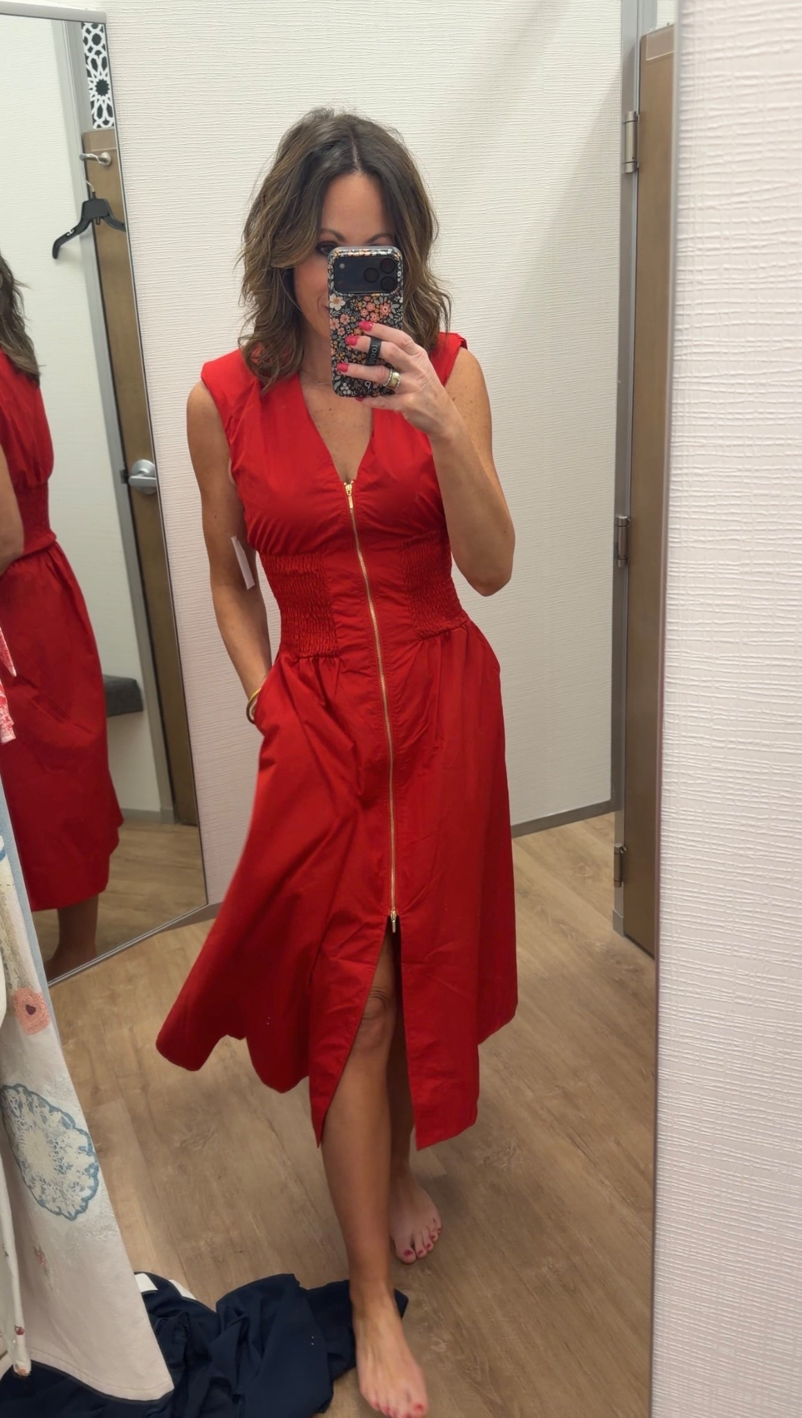 OK, I am absolutely obsessed with his stress. As soon as I saw it, I had to try it on. Zipped all the way down, is a bright cherry red, which is perfect for the upcoming summer holidays, or anytime, frankly. It makes you look super tan, and is super flattering. There are shoulder pads, barely in the cap sleeve, which leads to such a nice structure. The hardware is gold and you can zip more or less if you want it. A roasted stomach area so it’s stretches and is super comfortable to wear seriously so easy and pretty and comfortable.

#LTKTravel #LTKOver40 #LTKmomlife