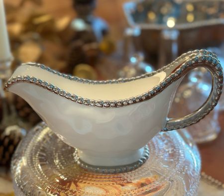 The perfect elegant+ easy care gravy boat.

Made of gleaming white porcelain with lustrous silver beads in titanium. 

Food safe. 
Oven safe to 350°. 
Easy Care


#gravyboat #entertainingmusthaves #holidayservingpieces 

#LTKhome #LTKHoliday