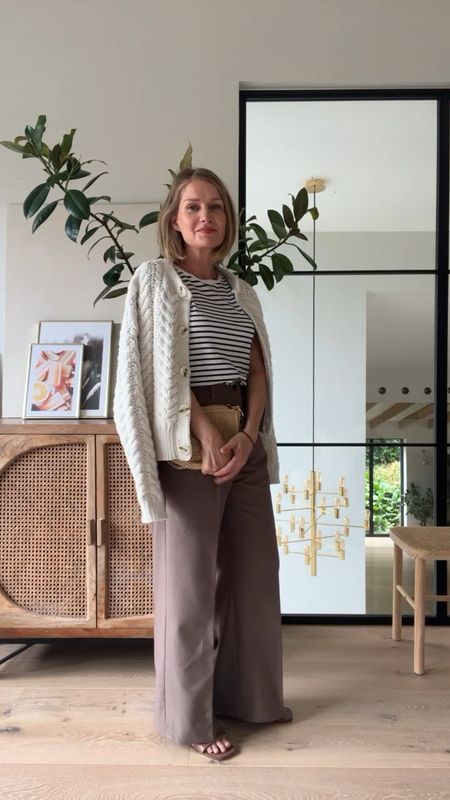 Wide-leg pleated trousers with a chunky cardigan and a striped t-shirt #autumnoutfit #transitionaloutfits

#LTKunder50 #LTKeurope #LTKSeasonal