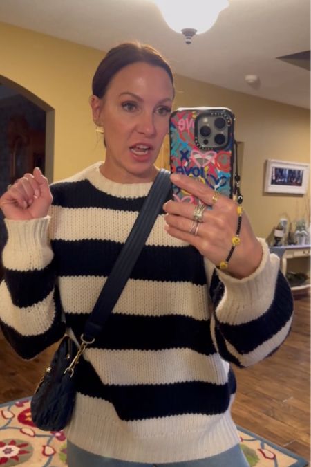  I love an oversized black and white striped sweater situation. Sweater and jeans are Frame. Paired with jeans, my Gucci sneakers and my favorite phone case that adds just the right amount of pop! Wearing size small in sweater, size 25 in jeans and size 7.5 in sneakers. 

#LTKover40 #LTKSeasonal #LTKshoecrush