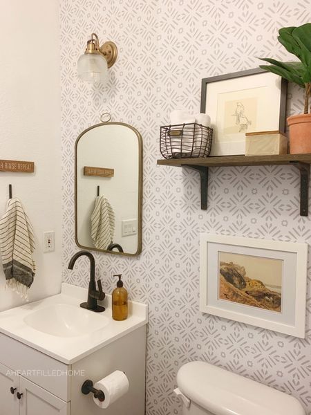 Bathroom decor including wallpaper, wall mirror, shelf, art, light, vanity, hooks, towels, and more!

#LTKunder50 #LTKunder100 #LTKhome