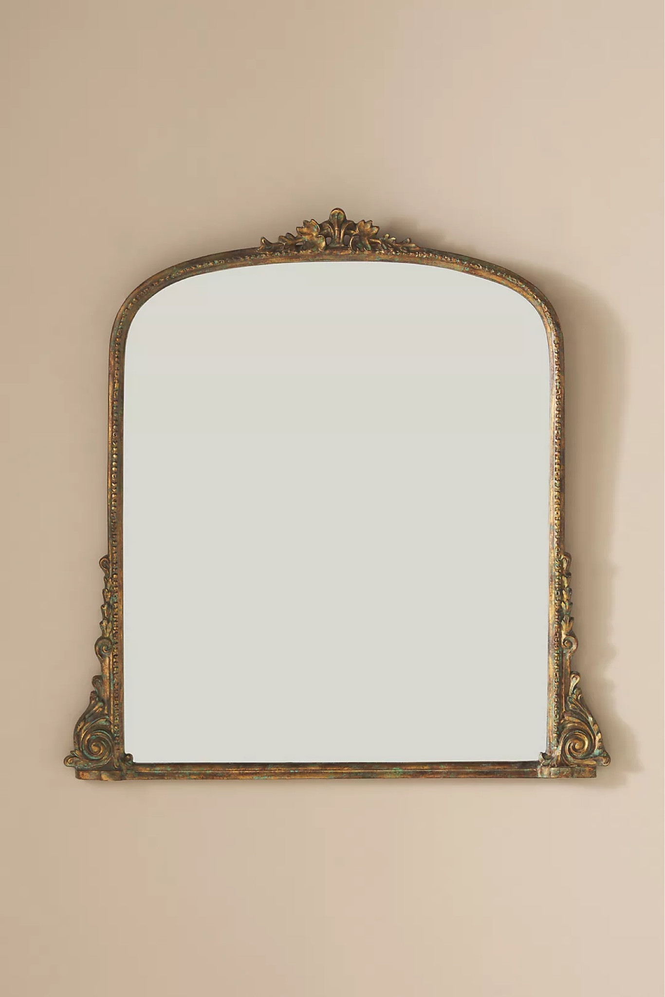 tunning, vintage-inspired, and social-media-famous, the Gleaming Primrose Mirror is our bestselling style of all time. It's an icon, beloved for its exquisite details, including elegant adornments along its apex and edges. Available in a wide range of sizes, shapes, and finishes to suit and magnify petite nooks and grand interiors alike, it reflects the best of your space (and your taste!), wherever it's placed. 

Due to the handcrafted nature of this piece, minor variations in the reflection can occur along the edges of the glass.

Handcrafted resin, iron, engineered hardwood, mirrored glass
Three-foot mirrors are fitted with a ready-to-hang D-ring; hanging hardware is required. Anti-tip hardware kit is included and recommended if leaning.
Please Note: Mirrors sized at 5 feet and larger should not be hung; they are intended to be leaning/floor mirrors and anti-tip hardware is included and recommended. To avoid damage to the mirror's appearance and longevity, we recommend that the base be equidistant from the wall on both sides, with a 3.5"- 5" distance between the base of the frame and the wall. Details by size are listed below.
Wipe clean with dry cloth
Imported