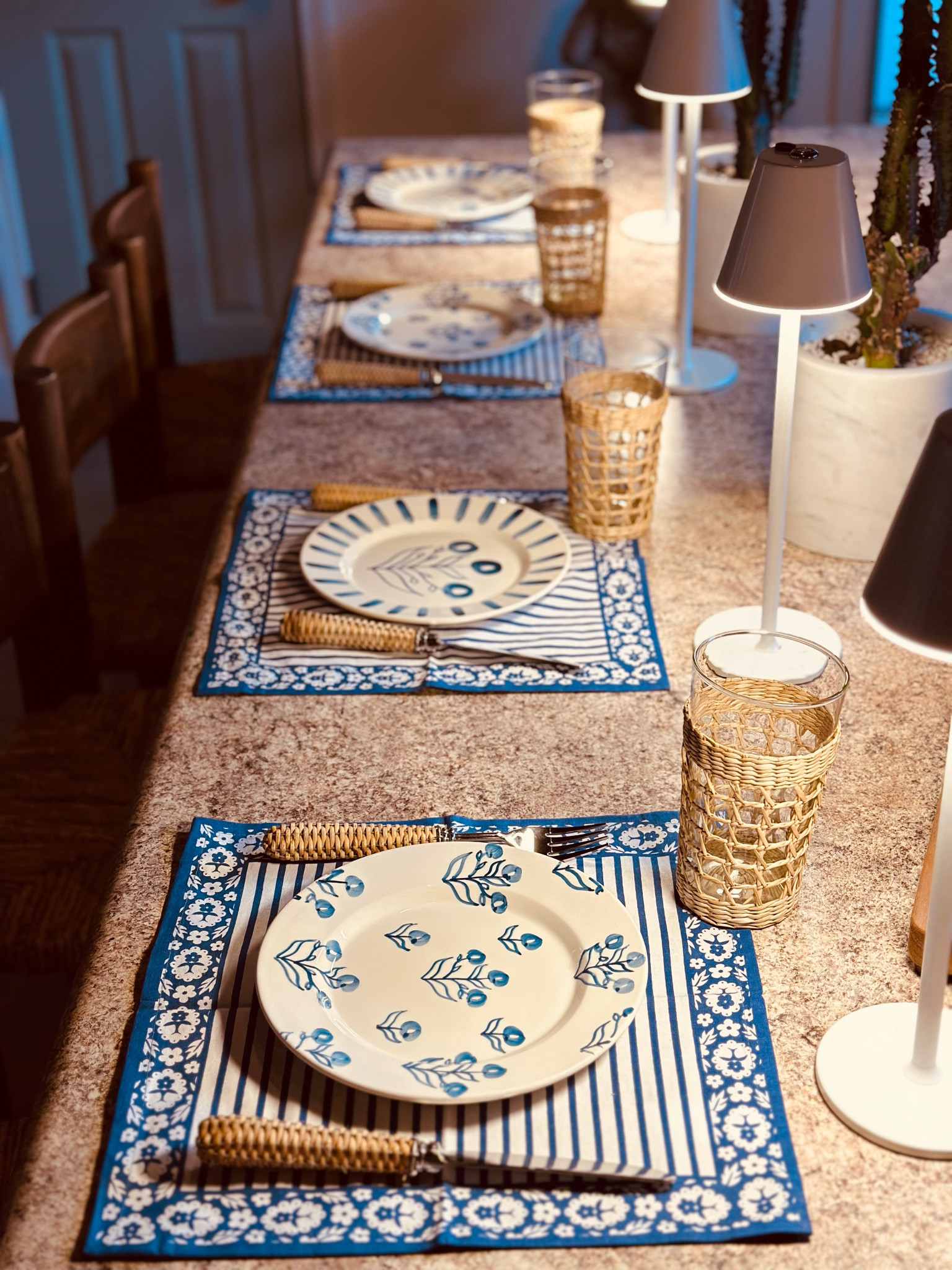 I set the breakfast bar with some new items today to make our Tuesday a little more exciting. I snagged these napkins about a month ago (also bought the matching tablecloth) and am using them as small placemats. Our bar has to fit four children so smaller placemats work better than full sized. 
These plates are last season Dondolo and are no longer sold so I found you some similar options. I love the color blue so I am a sucker for styles like this. 
This is the new silverware that I unboxed for you. It is hand wash only so I use it for myself or for small meals. It is heavy and gorgeous and easy for children to grip on to. It also makes such a statement on the table. 
These are the rattan glasses we always use and they are easy for everyone to grip and they also collect sweat- so save your tabletops! I use the pitcher too which helps everyone drink way more water. 
Lastly, each place got a rechargeable LED lamp. It makes each place setting look more special and the light really makes the food shine. I use these indoor and outdoor and even for extra light in dim spots of my kitchen. I got the Amazon ones but there is a designer version I tagged for you as well.

#LTKhome #LTKSeasonal #LTKsalealert