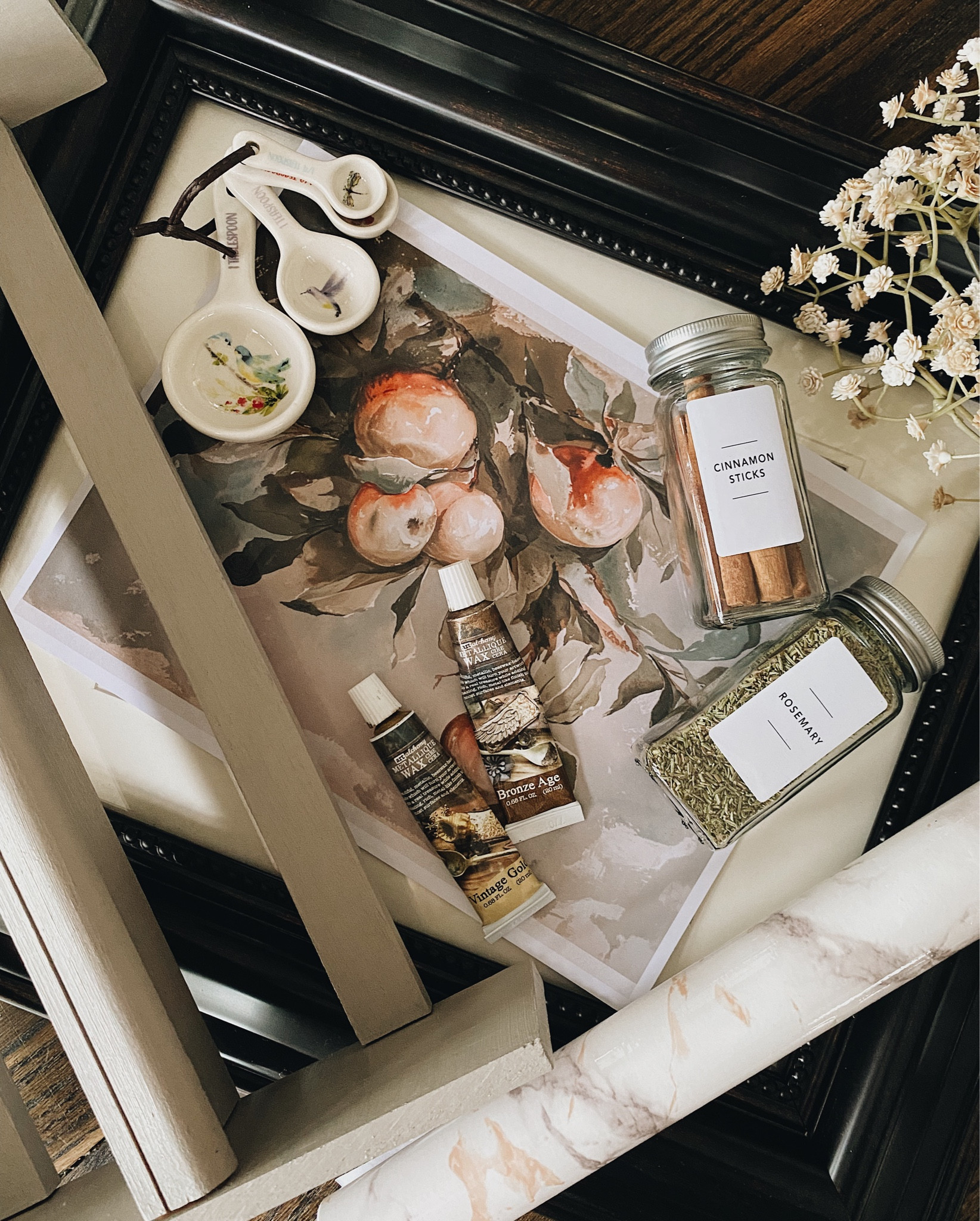 Flat lay of my next project! Wall mount spice rack upcycle supplies - modern spice jars, vintage artwork, metallique wax, rub n buff, peel and stick wallpaper 

#LTKunder50 #LTKhome #LTKFind