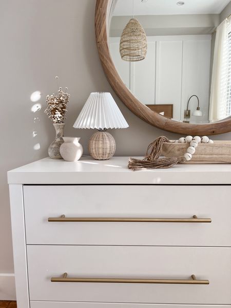 Bedroom dresser styling - I have this narrow white dresser that’s perfect for small spaces. I switched out the hardware to give it and affordable upgrade! I’m currently obsessing over this tiny rattan lank with a pleated shade, too! Follow for more bedroom decor inspo! 

#LTKhome #LTKunder50