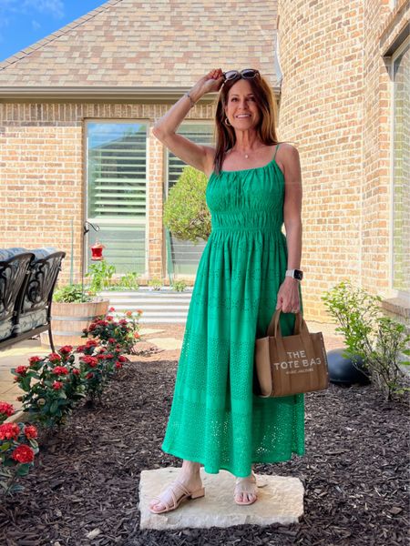 The beautiful grass green eyelet midi dress has a figure-flattering smocked waist. I'm wearing size XS here, but I actually exchanged it for a Small for a little more room in the bust area. I paired it with my Marc Jacobs small jacquard tote and a pair of strappy slides.
#vacationlook #summerfashion #midlifestyle #traveloutfit

#LTKstyletip #LTKSeasonal #LTKtravel