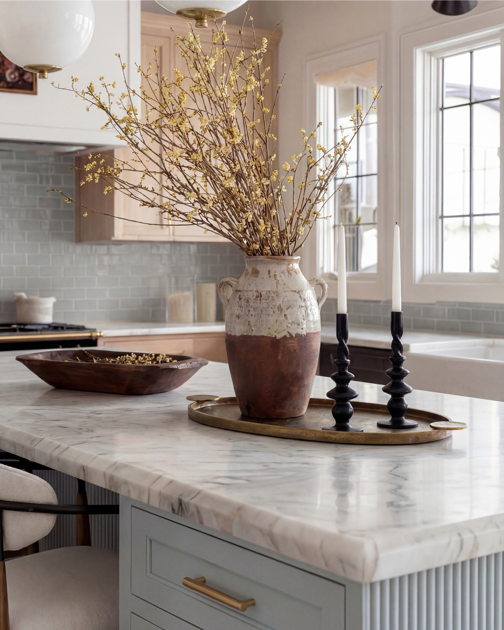 This kitchen is the definition of soft luxury done right. The pale blue island brings a calm, collected energy, while the warm oak cabinetry and exposed beams add that natural depth you can’t fake.

The oversized globe pendants keep everything feeling airy and modern, and the marble countertop? Effortless elegance. Even the runner pulls the whole palette together with those muted blues and warm neutrals.

It’s the kind of space that feels lived-in yet elevated—where morning coffee somehow tastes better and slow dinners feel intentional.

Shop the Look:
• Light blue fluted kitchen island
• Warm oak kitchen cabinets
• Brass globe pendant lights
• Marble kitchen countertop
• Neutral blue patterned runner
• Black + brass bar stools
• Soft blue subway tile backsplash
• Brown Ceramic vase with branches
• Gold kitchen faucet and hardware
• Brown bowl 
• Brown floral wall art
• Black candle holder

#LTKsale #LTKhome #LTKstyletip