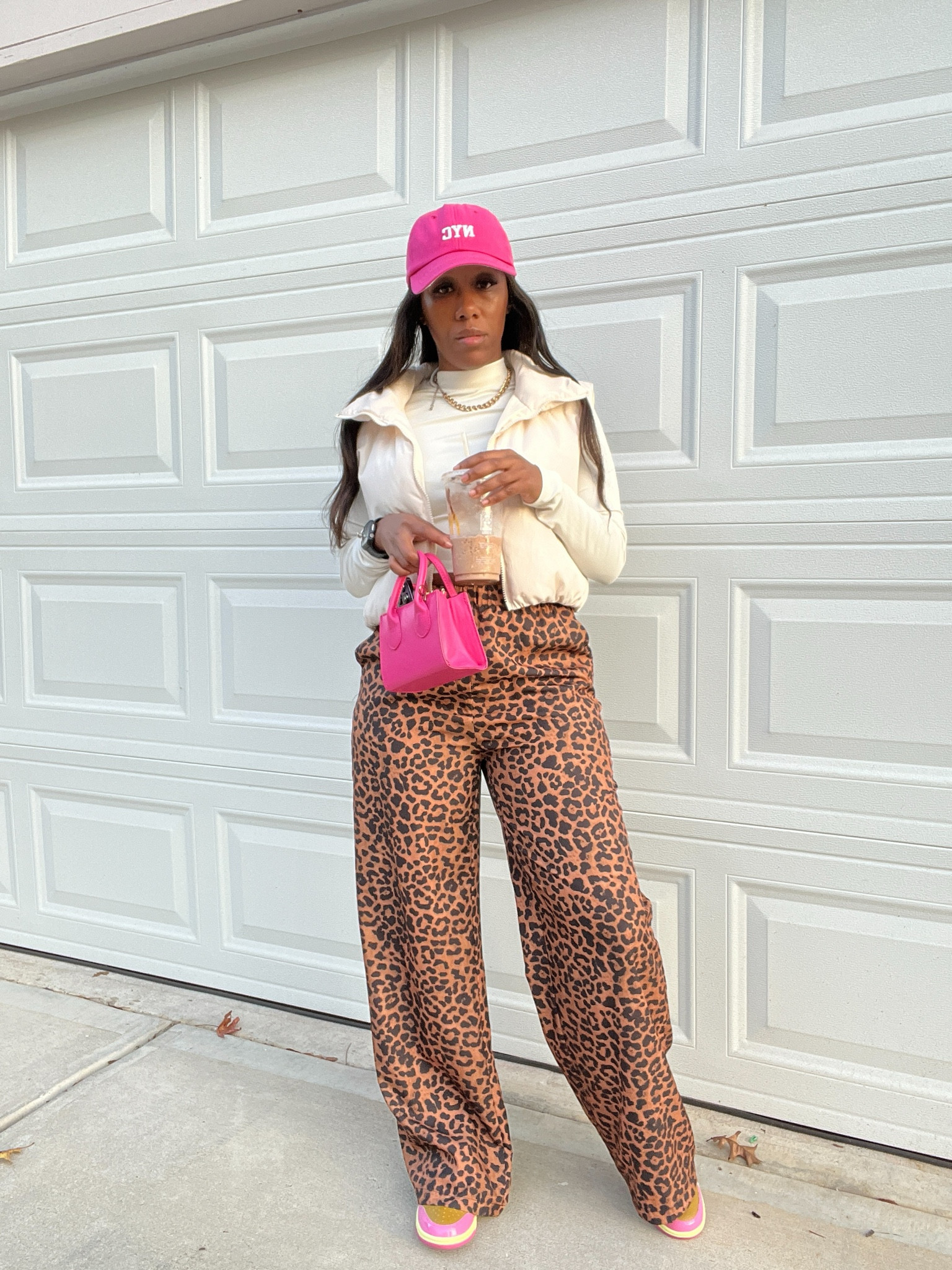 How to style leopard print pants with a beige puffer vest, beige long sleeve shirt, pink baseball hat, pink purse, and pink Nike dunk low Parris Goebel sneakers

#LTKStyleTip #LTKShoeCrush #LTKOver40