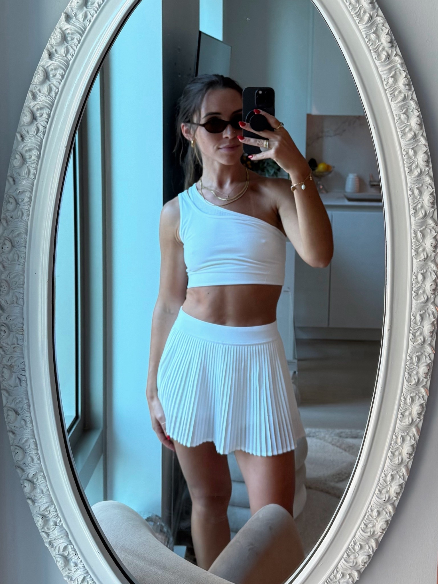 white workout set with the cutest pleated skirt 🥥