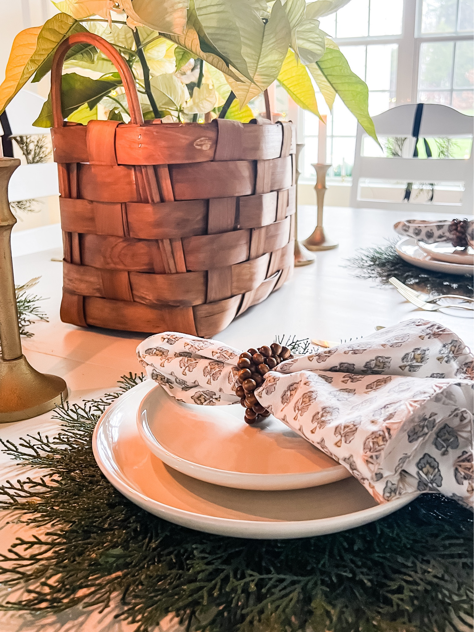 Style a simple but beautiful table for your New Year holiday celebration. Trillium linen napkins from August Table help elevate your design. White dinnerware with gold flatware add to the easy tablescape. Fun faux cedar placemats give a natural vibe. Centerpiece with a basket filled with poinsettias and gold candlesticks complete the look. #tablescape #holidaytable #bohostyle

#LTKhome #LTKHoliday #LTKSeasonal